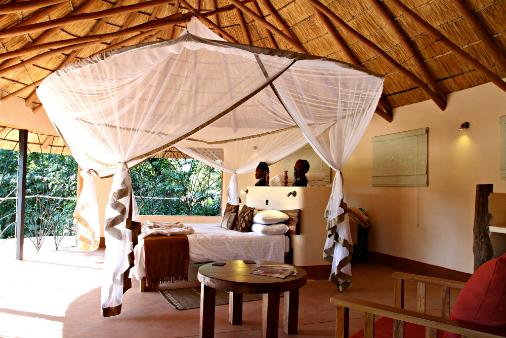 The bedroom of the Tongole Wilderness Lodge in Malawi, a treehouse designed by Blue Forest. 